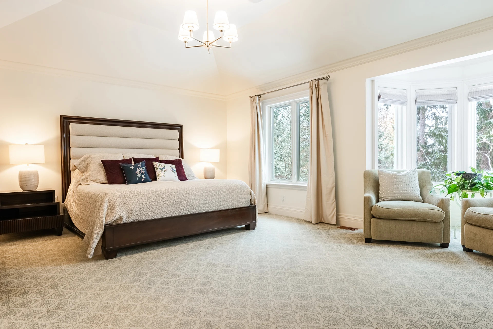 Spacious bright primary bedroom with clean wall-to-wall carpeting
